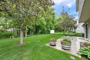 View of green lawn featuring a patio area