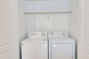 Washroom featuring independent washer and dryer