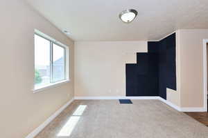 Empty room with carpet floors and baseboards