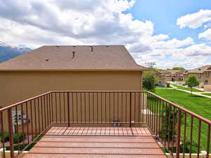 Wooden deck with a residential view and a lawn
