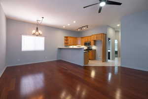 View of living room and kitchen.  Counter height breakfast bar.
