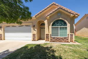 Mediterranean / spanish house with a garage, concrete driveway, stucco siding, a front lawn, and a tile roof