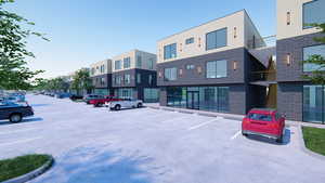 View of building exterior featuring uncovered parking