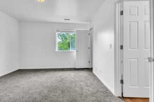 Primary  bedroom with carpet floors and baseboards