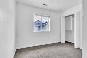 Second bedroom with carpet floors and baseboards