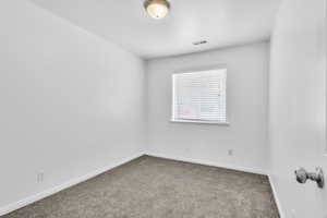 Third bedroom with carpet flooring and baseboards