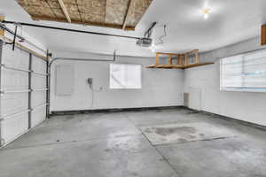 Garage featuring overhead storage and a garage door opener