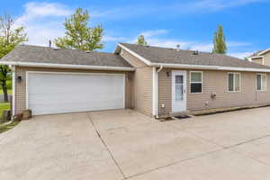 Ranch-style house with roof with shingles, concrete driveway, and a garage
