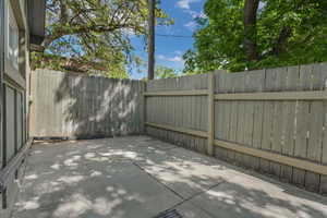 View of patio featuring fence.