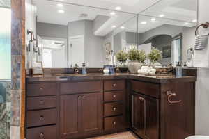 Bathroom featuring recessed lighting and double vanity.