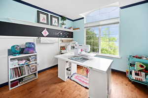 Office featuring hardwood / wood-style flooring and ornamental molding