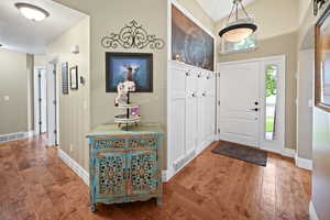 Entryway with wood finished floors and baseboards