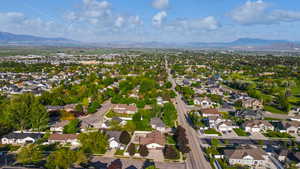 Aerial overview of property's location with a mountain backdrop and nearby suburban area