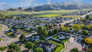 Aerial view of property's location featuring nearby suburban area and a mountain backdrop
