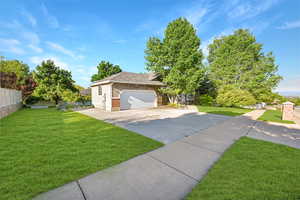 Obstructed view of property with brick siding, roof with shingles, and driveway