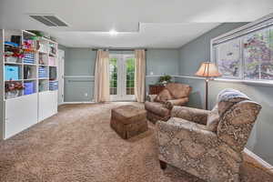 Living area with carpet flooring and baseboards