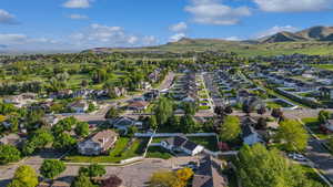 Aerial view of property's location with nearby suburban area and mountains