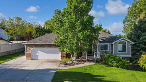View of front of home featuring roof with shingles, driveway, an attached garage, and brick siding