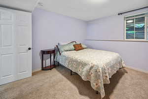 Bedroom featuring carpet flooring and baseboards