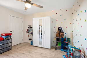 Game room with wood finished floors, a ceiling fan, and baseboards