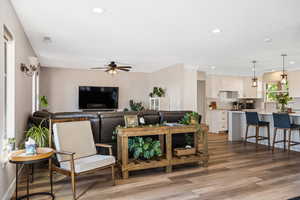 Living area featuring ceiling fan, light wood-type flooring, and recessed lighting