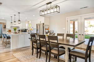 Dining space featuring light wood finished floors, french doors, and recessed lighting