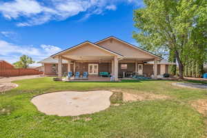 Rear view of property with ceiling fan, french doors, and a patio area