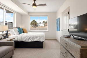 Bedroom with baseboards, light carpet, and a ceiling fan