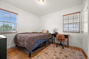 Bedroom featuring baseboards and wood finished floors