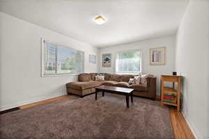 Living area featuring healthy amount of natural light, light wood-type flooring, and baseboards