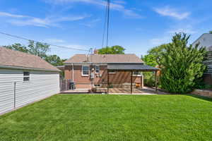 Rear view of property featuring a patio area, brick siding, a chimney, and roof with shingles
