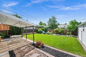 View of yard with a patio and outdoor dining space