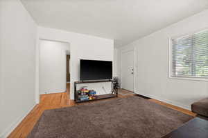 Living area with light wood-type flooring and baseboards