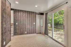 Empty room with wood walls and recessed lighting