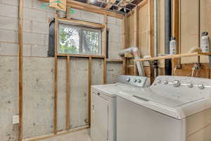 Clothes washing area featuring washing machine and clothes dryer