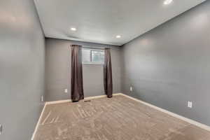 Spare room with light colored carpet, recessed lighting, and baseboards