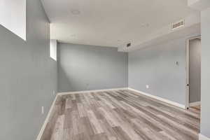Spare room with light wood-style flooring and baseboards