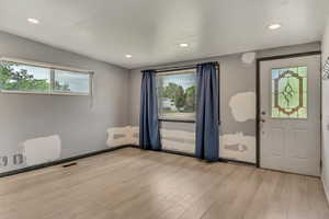 Entrance foyer featuring plenty of natural light, light wood-type flooring, and recessed lighting