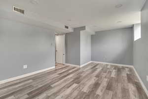 Unfurnished room featuring wood finished floors and baseboards