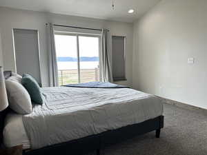 Carpeted bedroom featuring baseboards, recessed lighting, and a mountain view