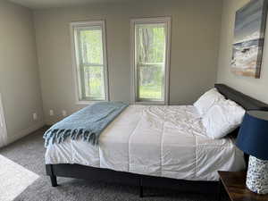 Bedroom featuring carpet flooring and baseboards