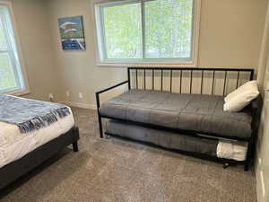 Bedroom with carpet floors and baseboards