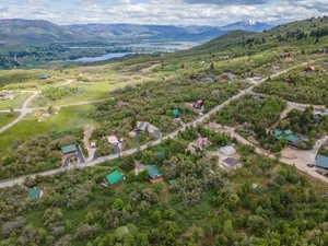 Aerial view of property and surrounding area with a water and mountain view