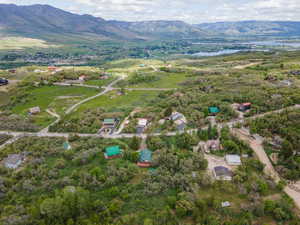 Aerial view of property and surrounding area with a water and mountain view