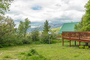 View of yard featuring a deck with mountain view