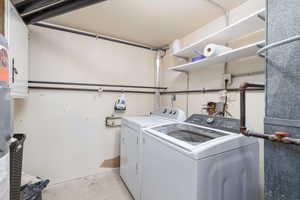Clothes washing area featuring washing machine and clothes dryer