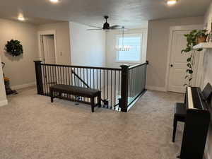 Hall featuring baseboards, light carpet, an upstairs landing, and recessed lighting