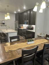 Kitchen with stainless steel appliances, a sink, dark wood-style flooring, light countertops, and backsplash