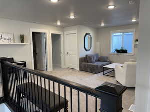 Living room with carpet, baseboards, and recessed lighting
