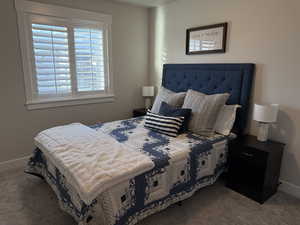 Carpeted bedroom with baseboards